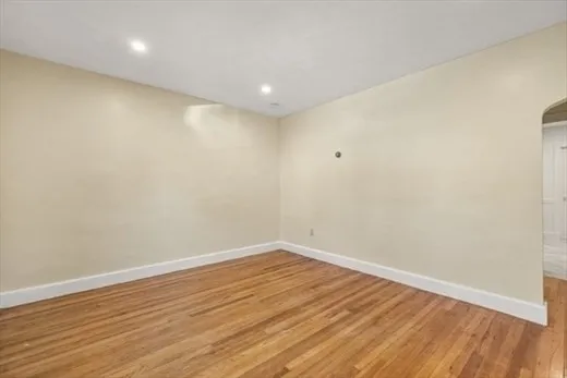 a view of room with wooden floor and fan