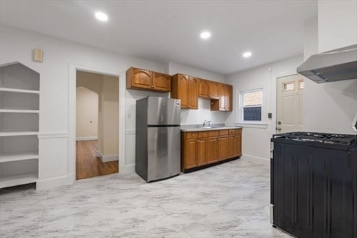 19 Beechcroft Street, Unit B Boston, MA 02135 - Photo 4 of 9 a kitchen with a refrigerator and a sink
