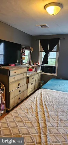 a room with a bed and a television