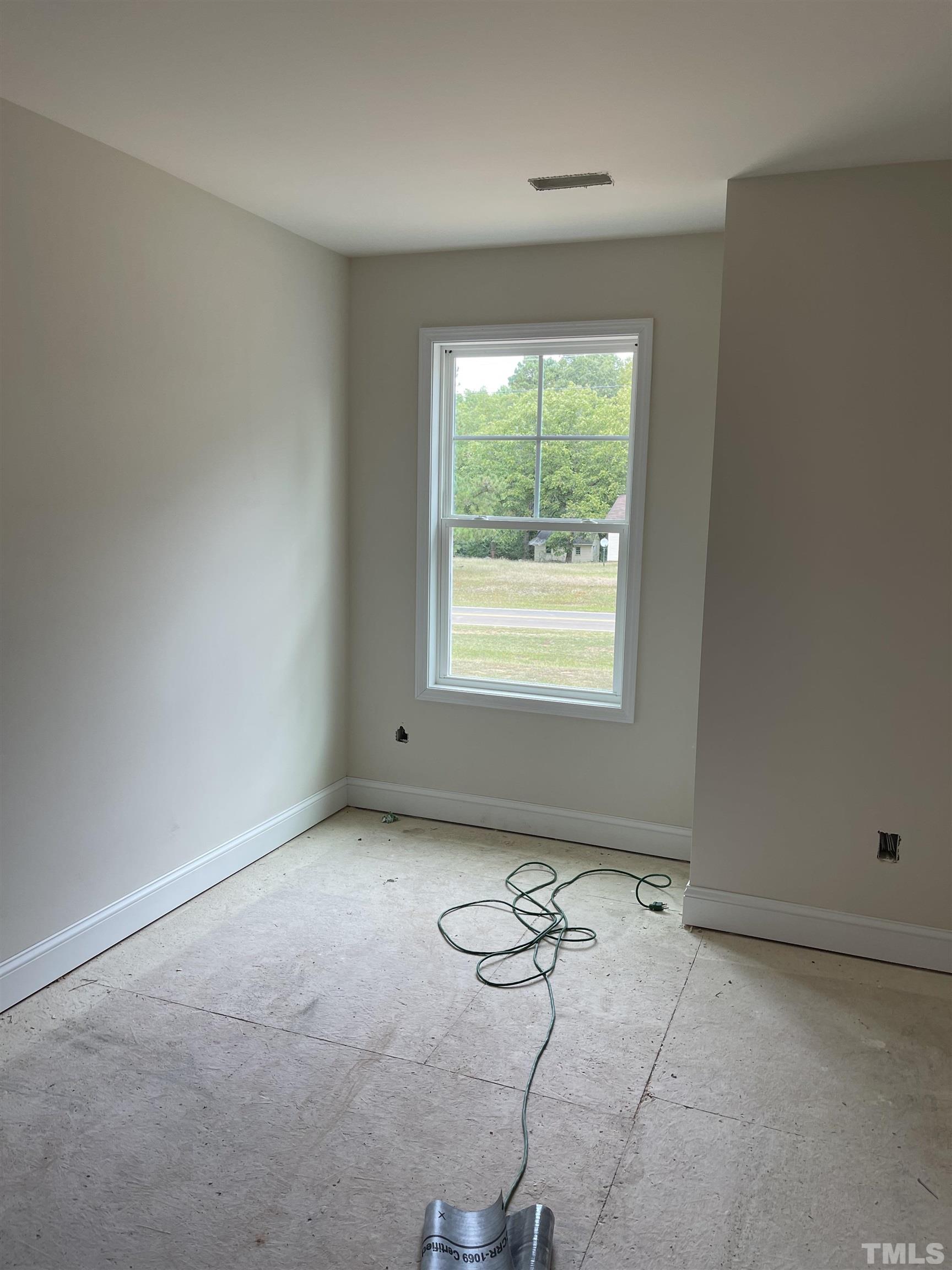 830 Mulberry Road Spring Hope, NC 27882 - Photo 16 of 18 an empty room with windows and carpet