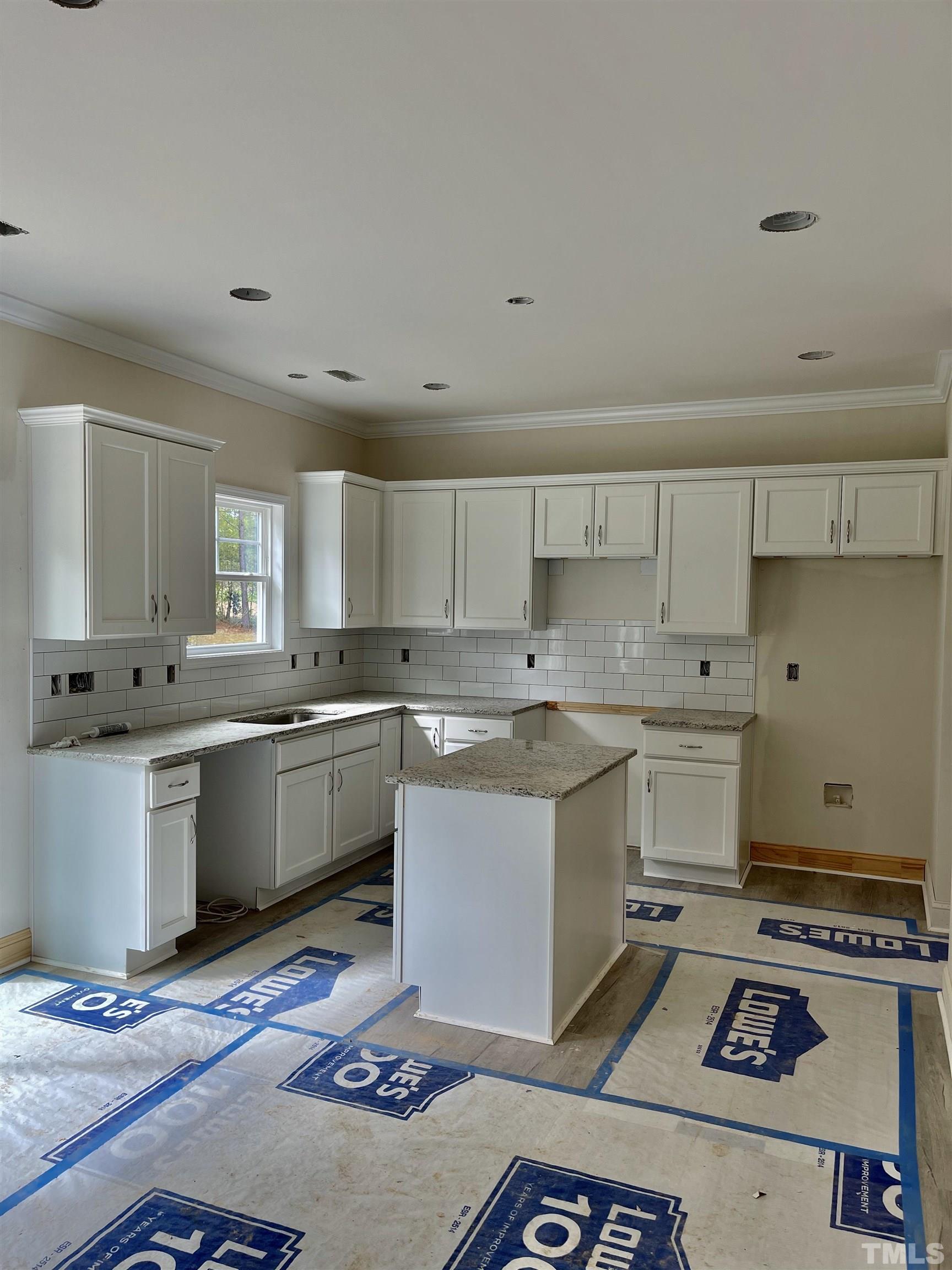 830 Mulberry Road Spring Hope, NC 27882 - Photo 8 of 18 a kitchen with a sink stove and white cabinets