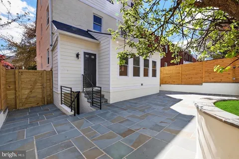 a front view of house with yard and outdoor seating