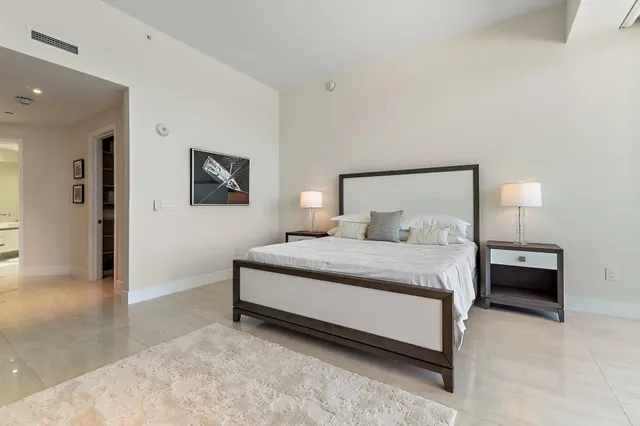 a bedroom with a bed and a lamp