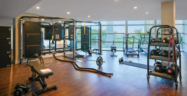 a living room with furniture gym equipment and a large window