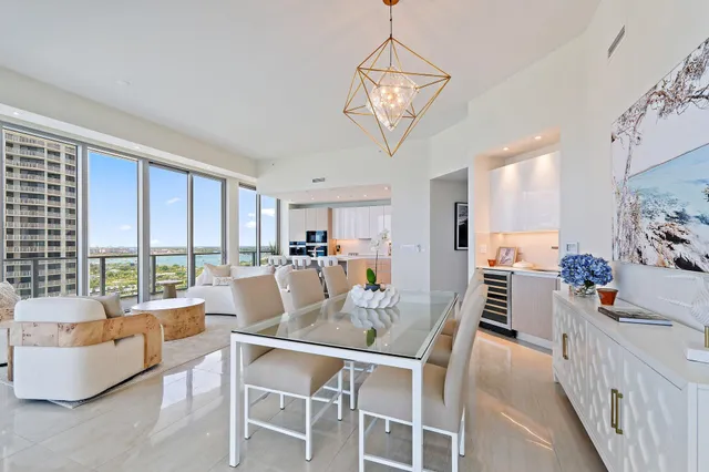 a dining room with furniture a chandelier and window
