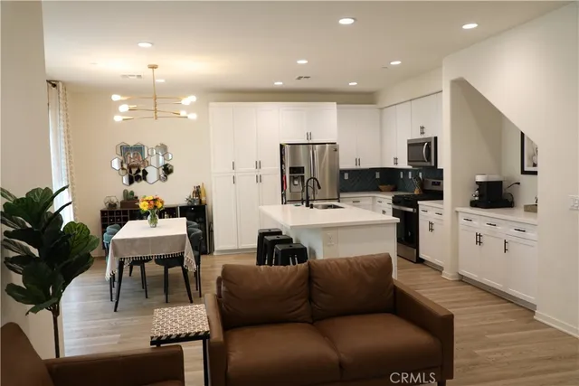 a living room with furniture and kitchen view