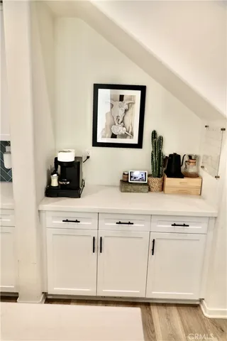 a close view of appliances cabinets and a bed