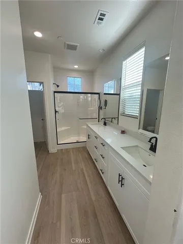 a bathroom with a double vanity sink and mirror