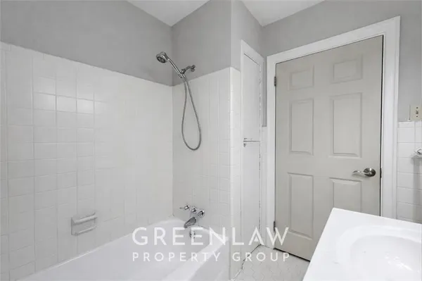 a bathroom with a granite countertop sink a mirror and shower
