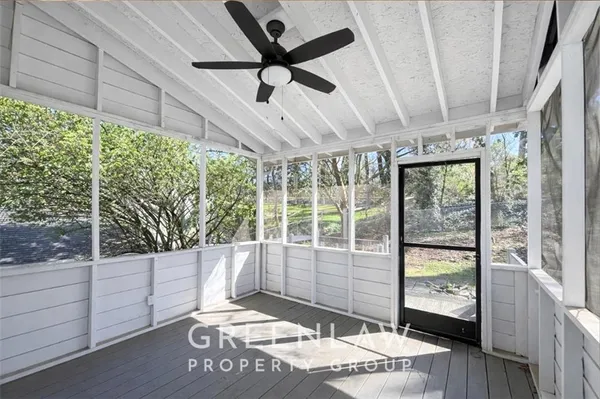 a living room with wooden floor and furniture