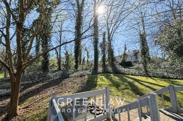 a view of a swimming pool with a patio and fire pit