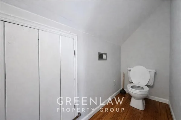 a bathroom with a toilet and a shower curtain