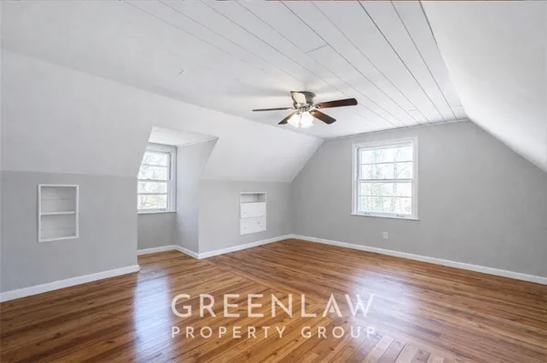 a view of a room with a window and wooden floor