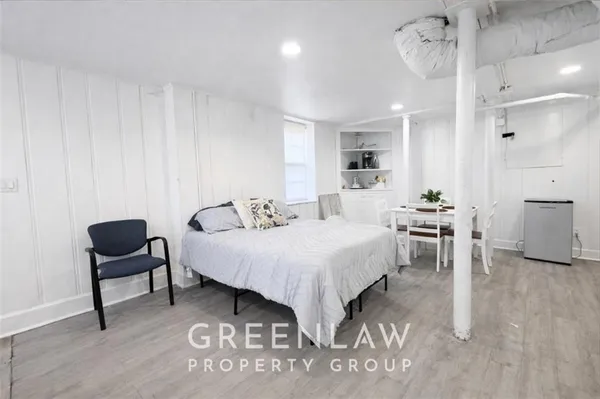 a bedroom with a bed and a chair