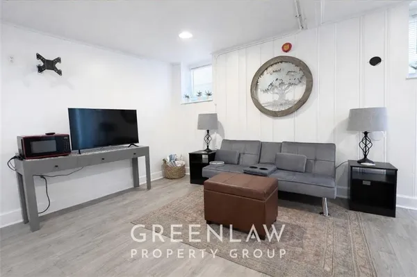 a living room with furniture and a flat screen tv