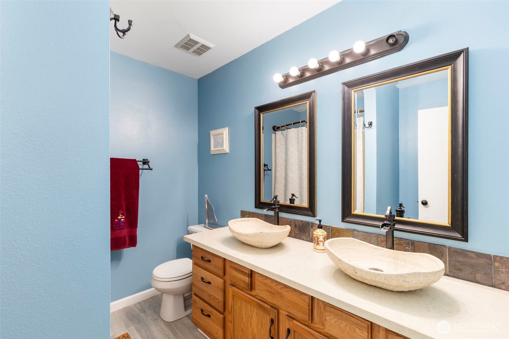 2954 Lowren Loop Port Orchard, WA 98366 - Photo 15 of 30 a bathroom with a granite countertop sink a toilet and mirror