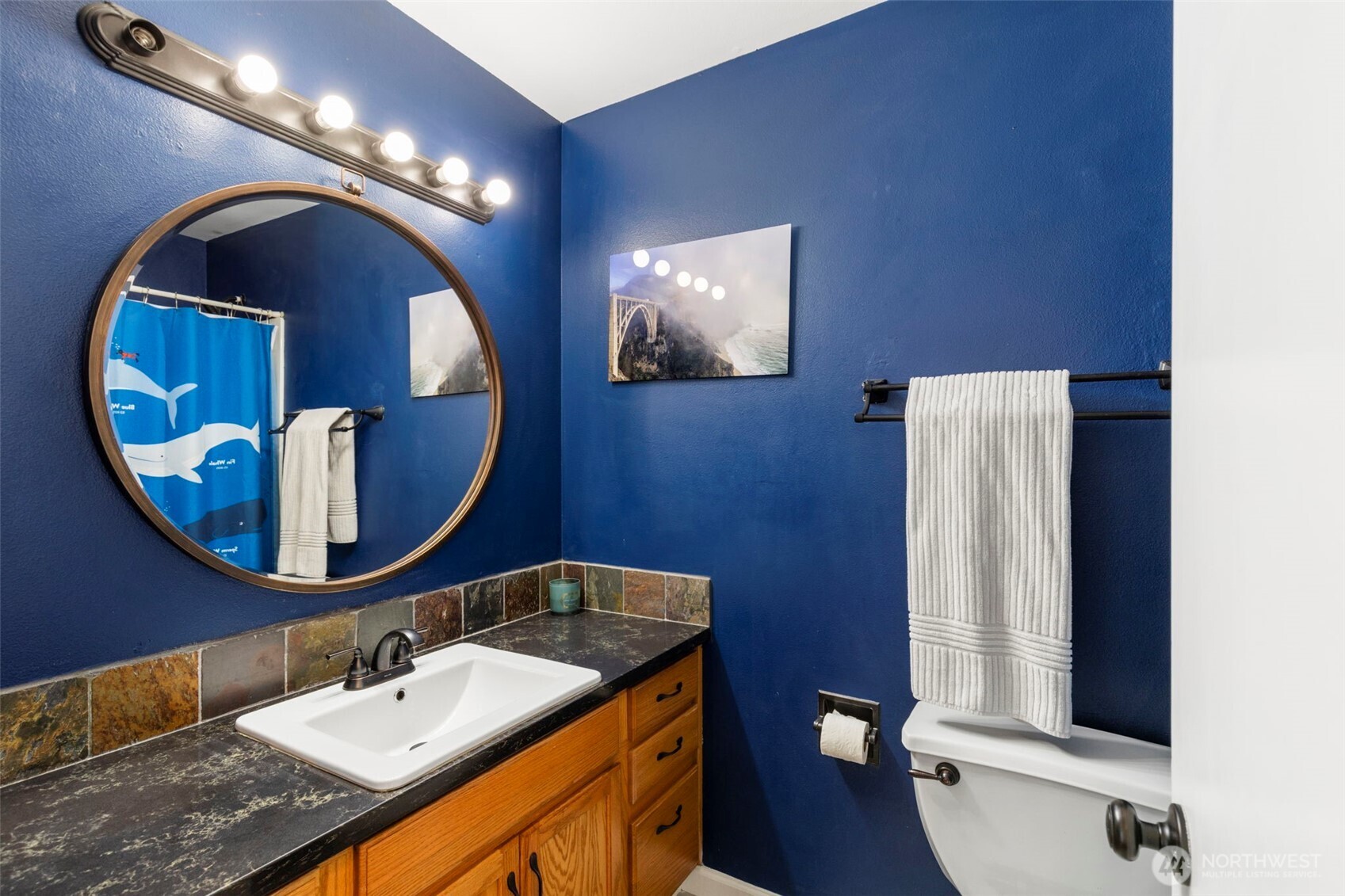 2954 Lowren Loop Port Orchard, WA 98366 - Photo 17 of 30 a bathroom with a toilet sink and mirror