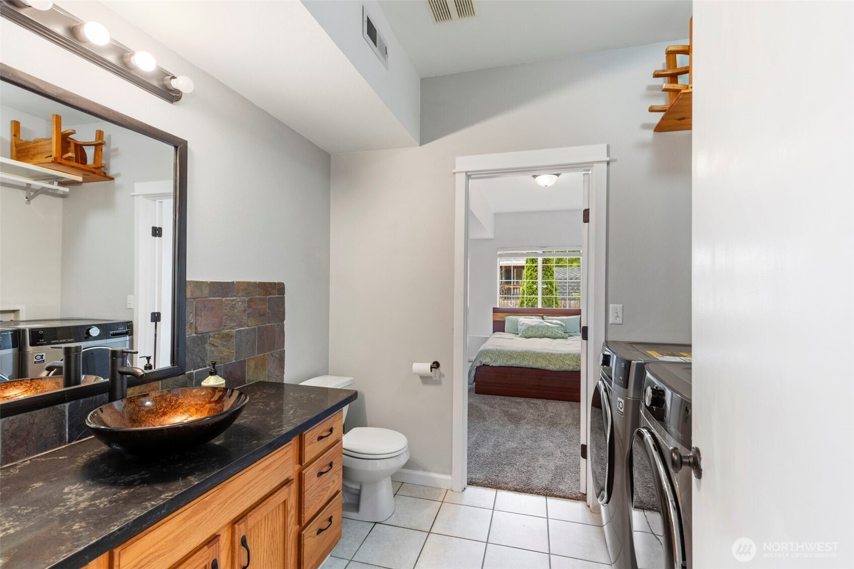 2954 Lowren Loop Port Orchard, WA 98366 - Photo 24 of 30 a bathroom with a granite countertop sink a toilet and a mirror