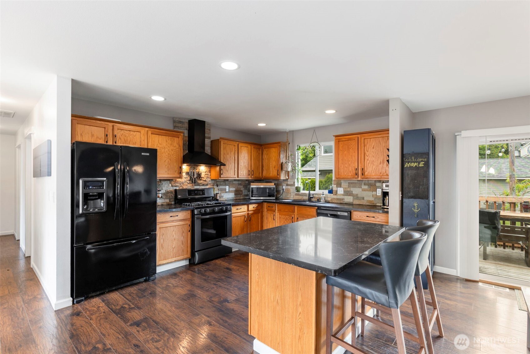 2954 Lowren Loop Port Orchard, WA 98366 - Photo 8 of 30 a kitchen with stainless steel appliances granite countertop a refrigerator a stove top oven and a sink