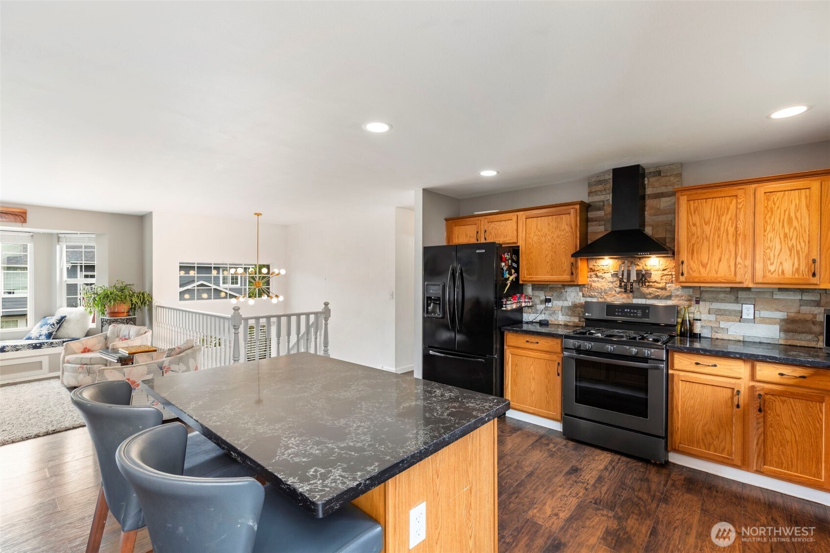 2954 Lowren Loop Port Orchard, WA 98366 - Photo 9 of 30 a kitchen with stainless steel appliances granite countertop a stove a refrigerator and a dining table