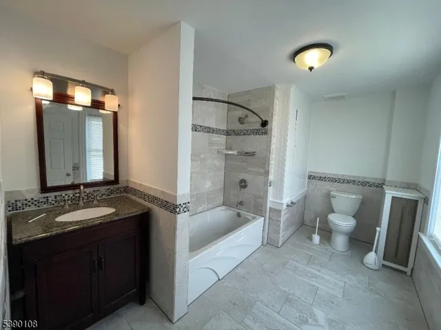 a spacious bathroom with a double vanity sink toilet and shower