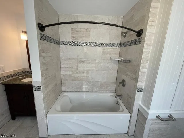 a bathroom with a tub and a shower