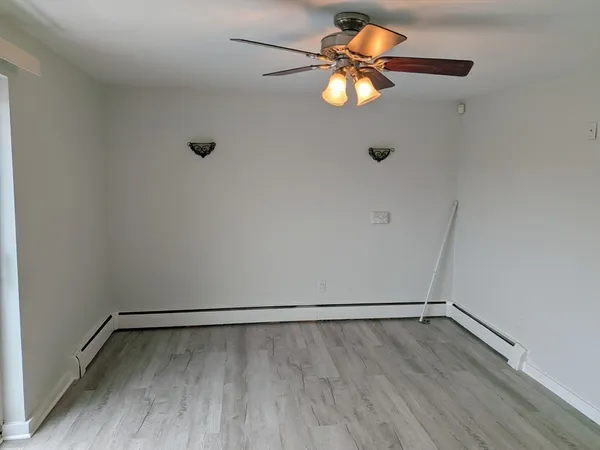 a view of an empty room with wooden floor