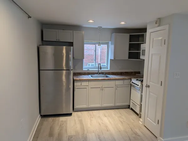 a kitchen with a refrigerator and a sink