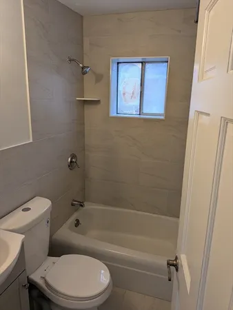 a bathroom with a toilet and a tub