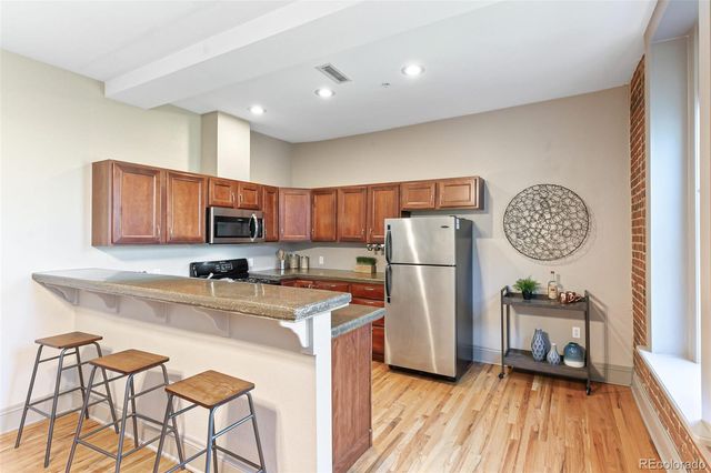 a kitchen with refrigerator a stove a sink and a cabinets