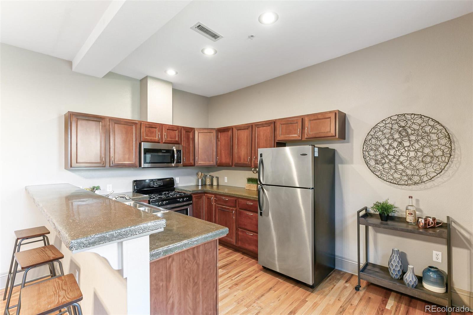 3211 Zuni Street, Unit 4 Denver, CO 80211 - Photo 15 of 35 a kitchen with a refrigerator a stove a sink cabinets and wooden floor