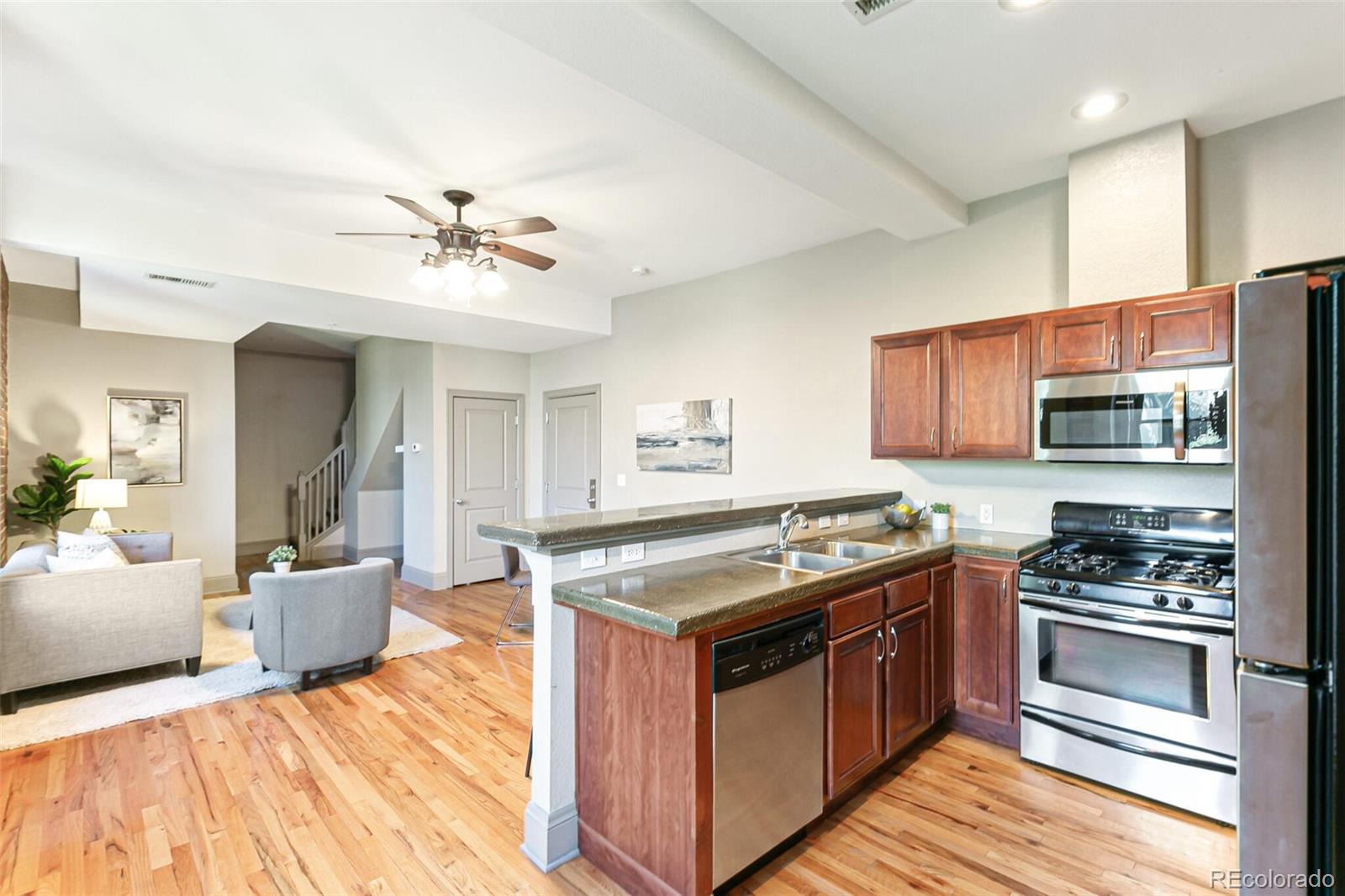 3211 Zuni Street, Unit 4 Denver, CO 80211 - Photo 18 of 35 a kitchen with stainless steel appliances granite countertop a stove and a sink