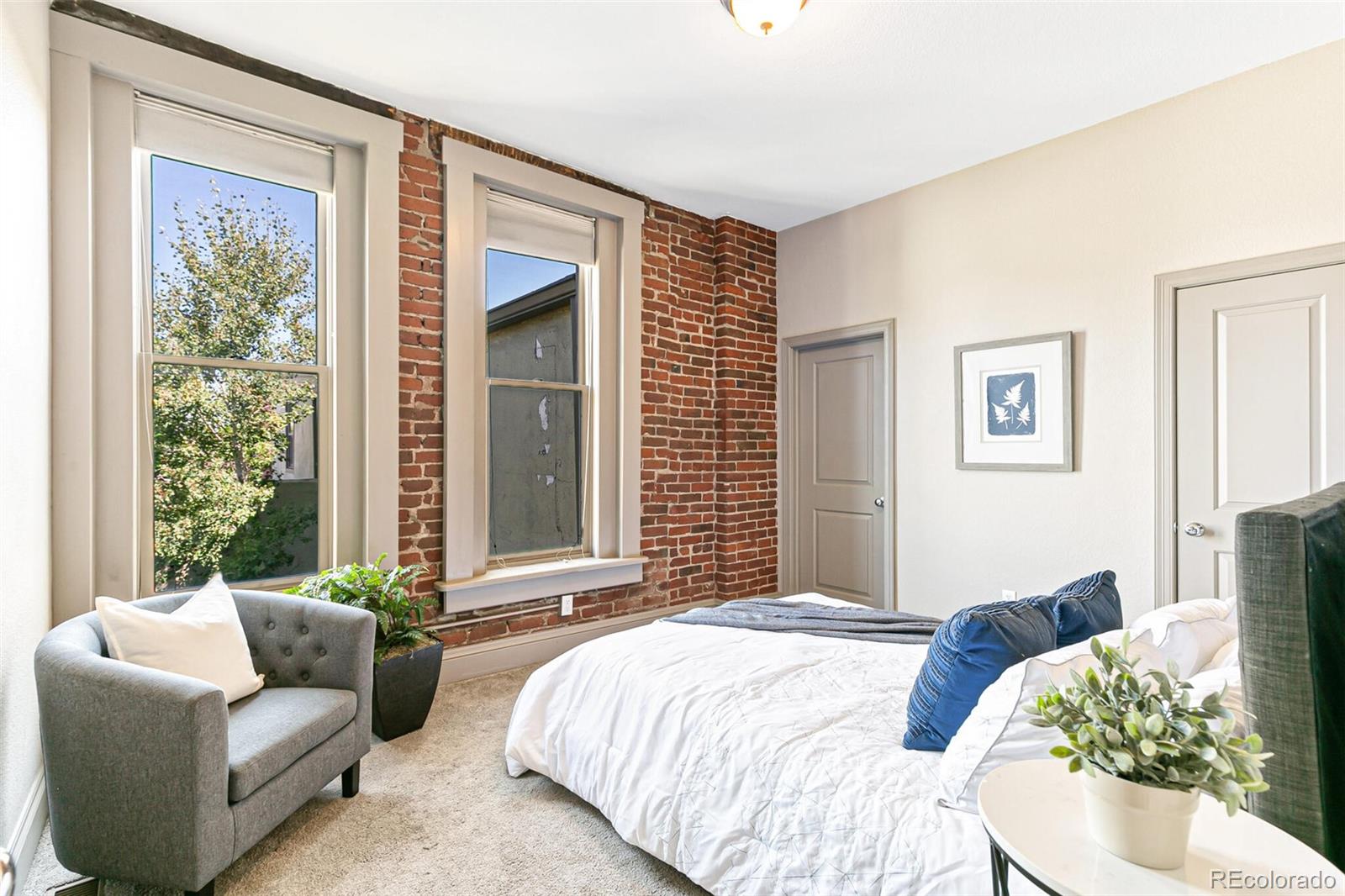 3211 Zuni Street, Unit 4 Denver, CO 80211 - Photo 22 of 35 a bedroom with bed couch and window