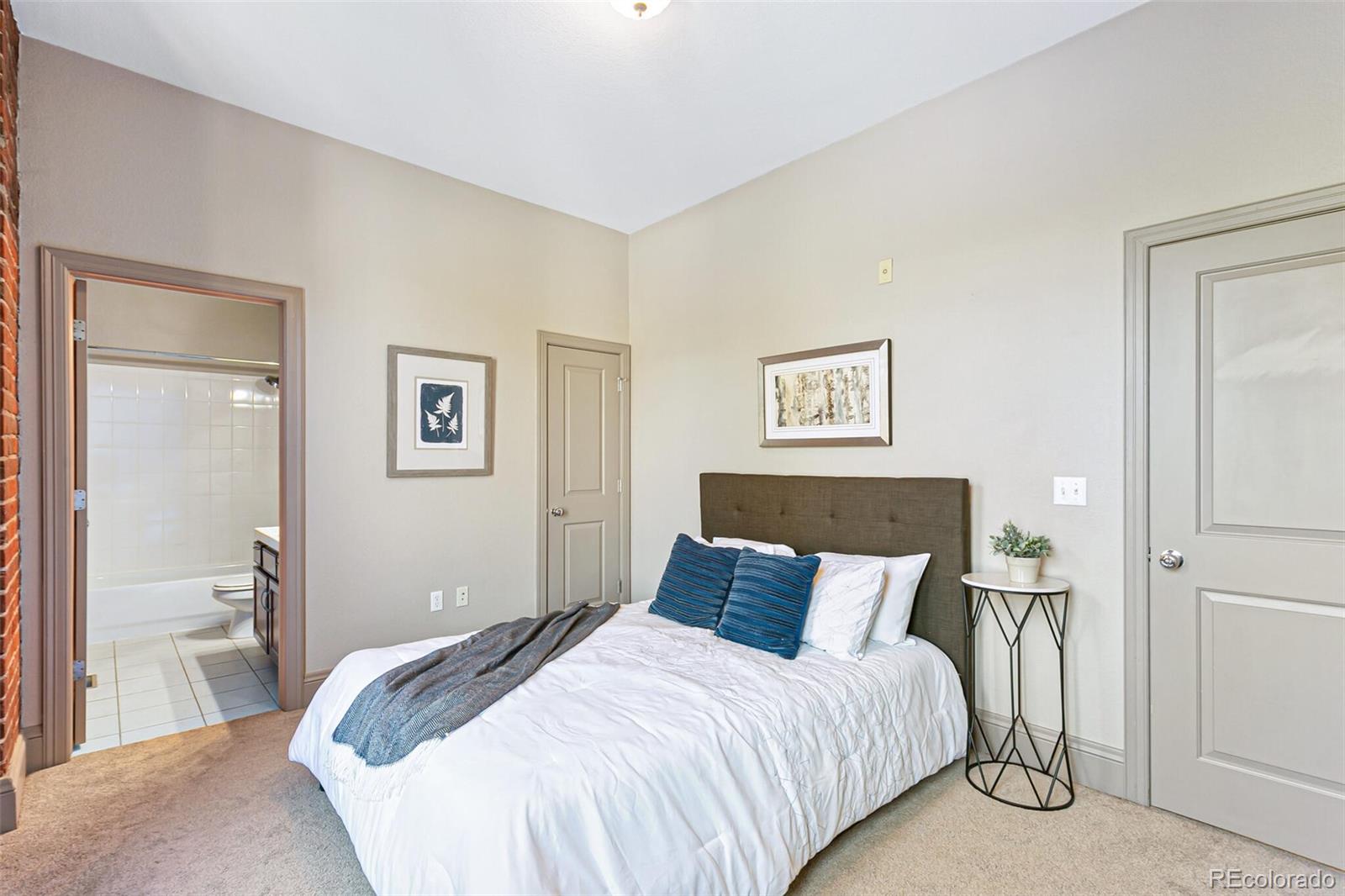 3211 Zuni Street, Unit 4 Denver, CO 80211 - Photo 23 of 35 a bedroom with a bed and a view of bathroom
