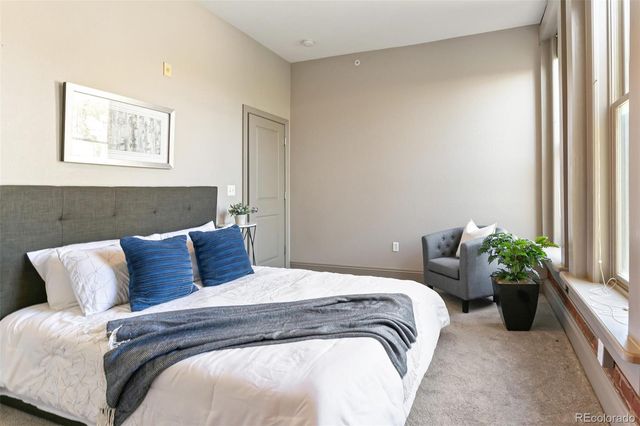 a bedroom with a bed and a potted plant