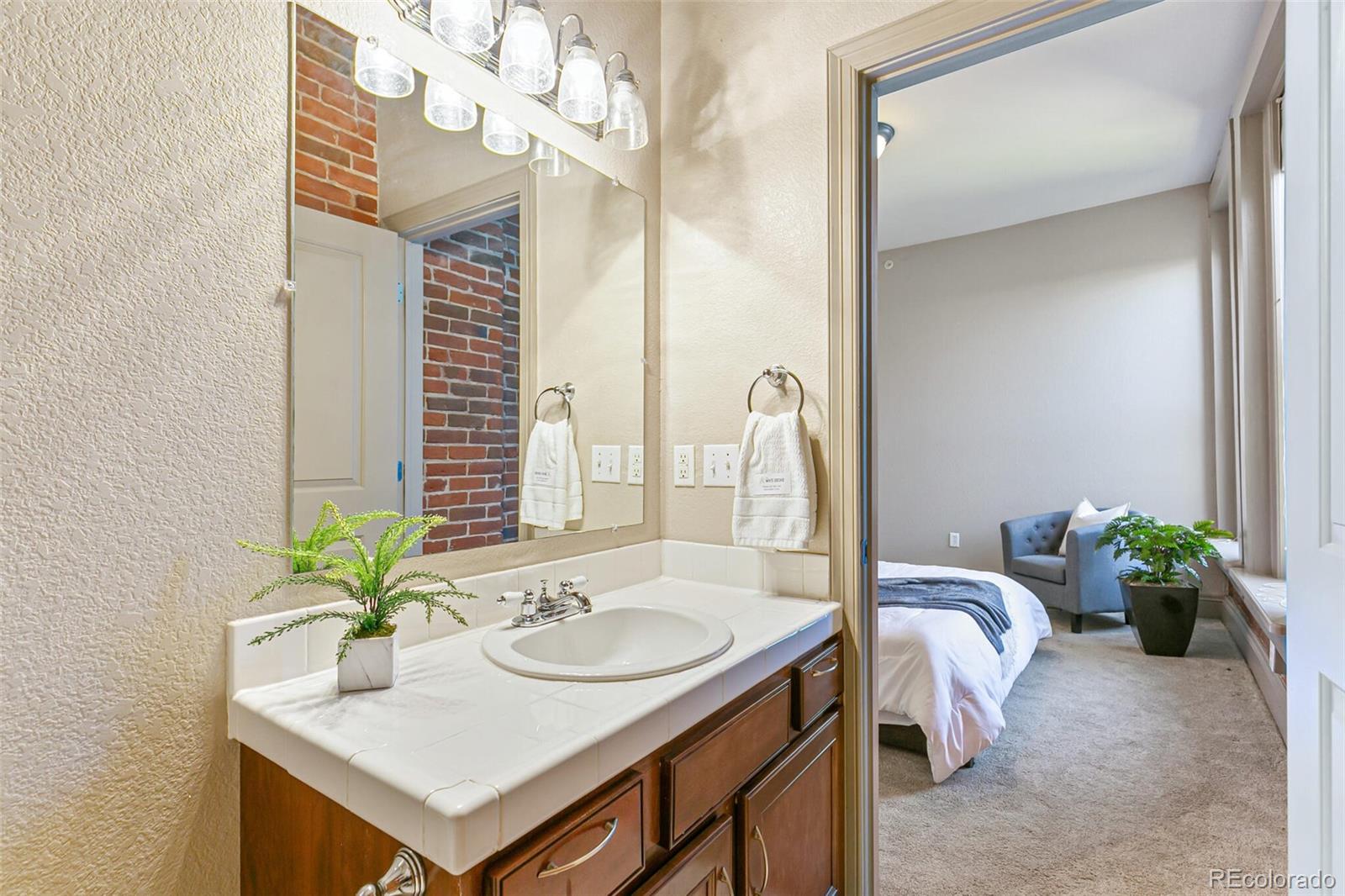 3211 Zuni Street, Unit 4 Denver, CO 80211 - Photo 25 of 35 a bathroom with a sink a faucet and a mirror