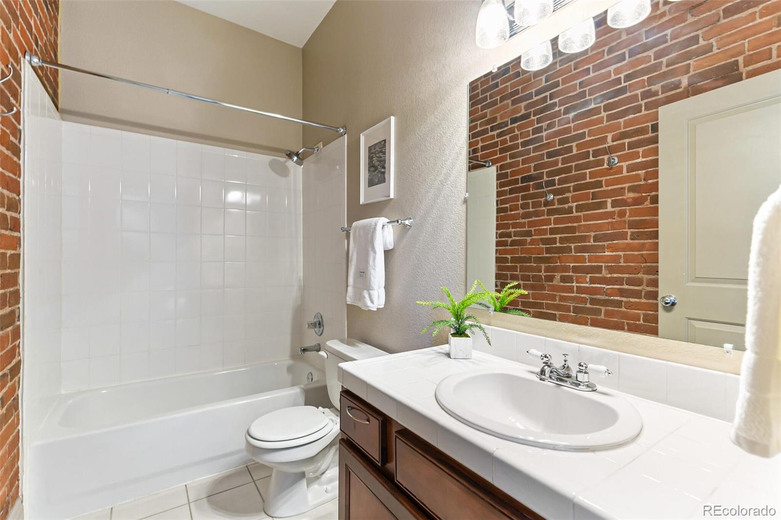 3211 Zuni Street, Unit 4 Denver, CO 80211 - Photo 26 of 35 a bathroom with a sink toilet tub and shower
