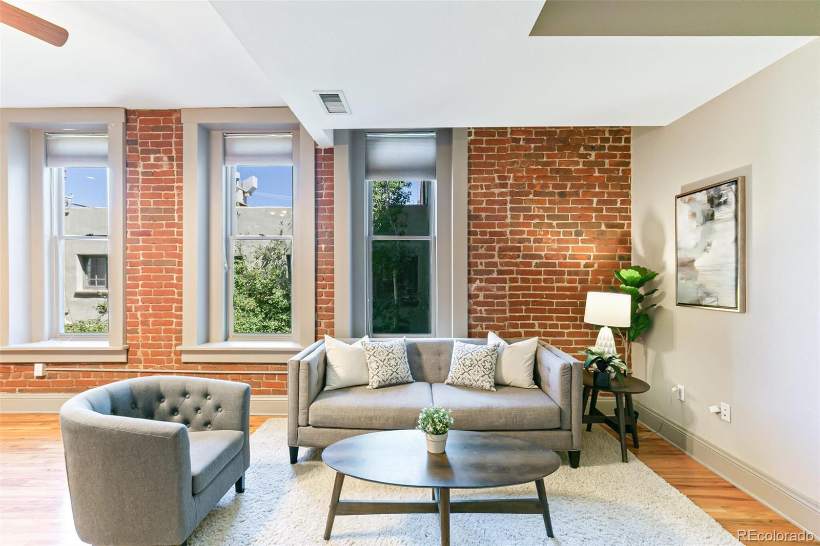 3211 Zuni Street, Unit 4 Denver, CO 80211 - Photo 6 of 35 a living room with furniture and a large window