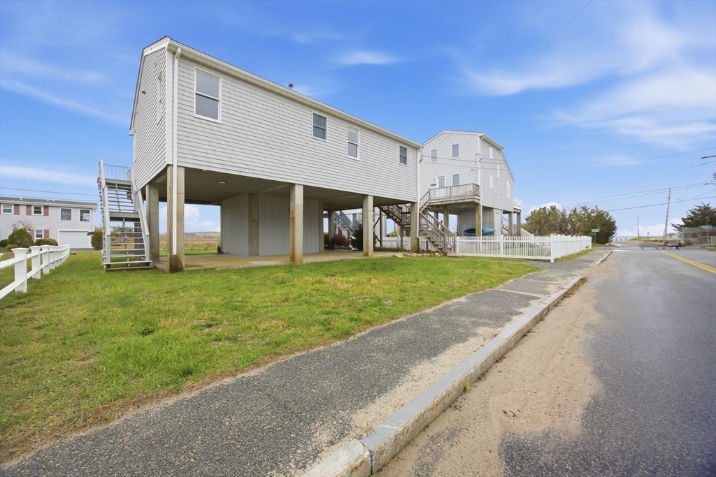 192 Swifts Beach Road Wareham, MA 02571 - Photo 4 of 38 a view of a house with a big yard and large trees