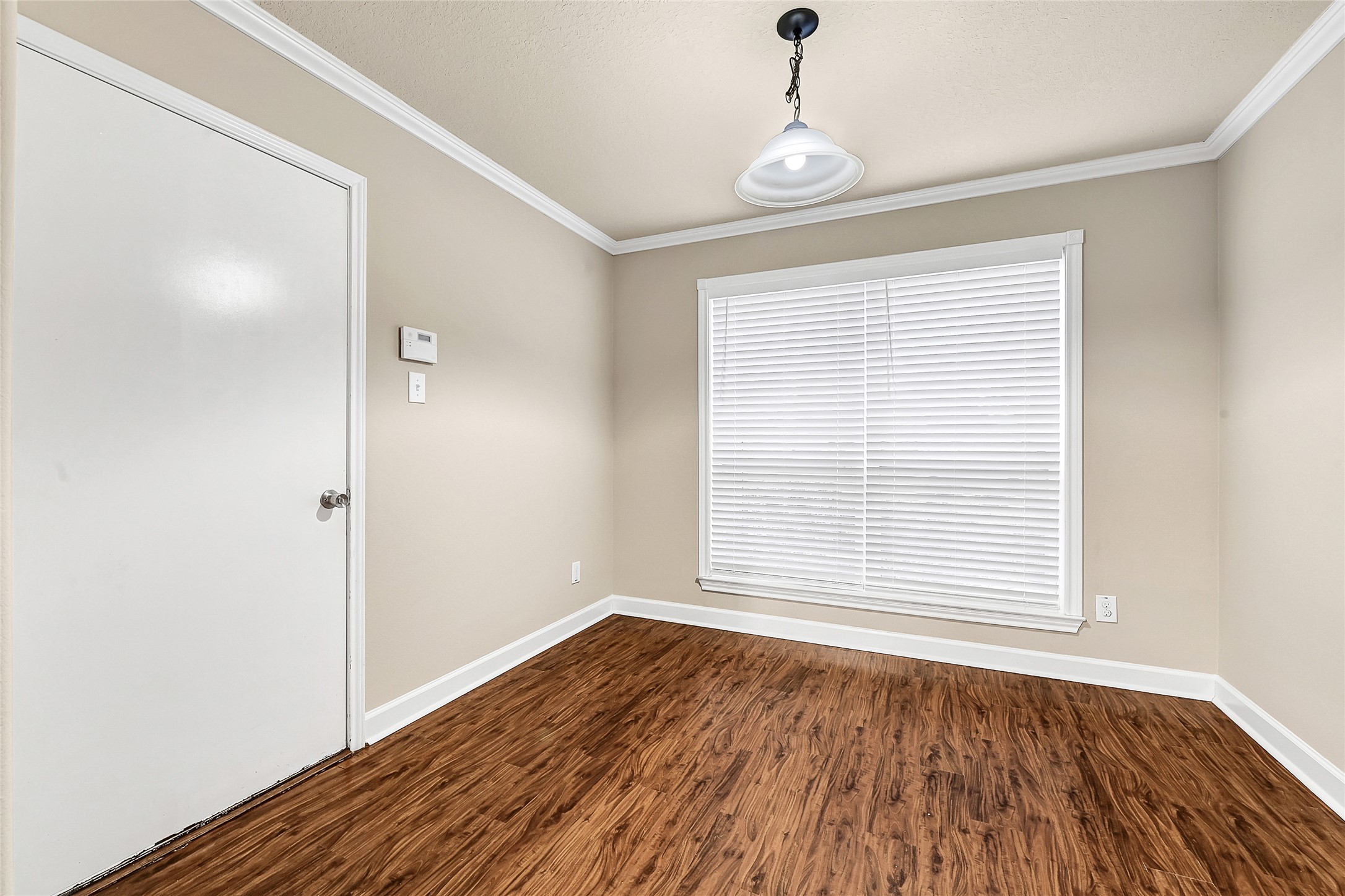 3603 Barkers Crossing Avenue Houston, TX 77084 - Photo 11 of 34 a view of an empty room with wooden floor and a window