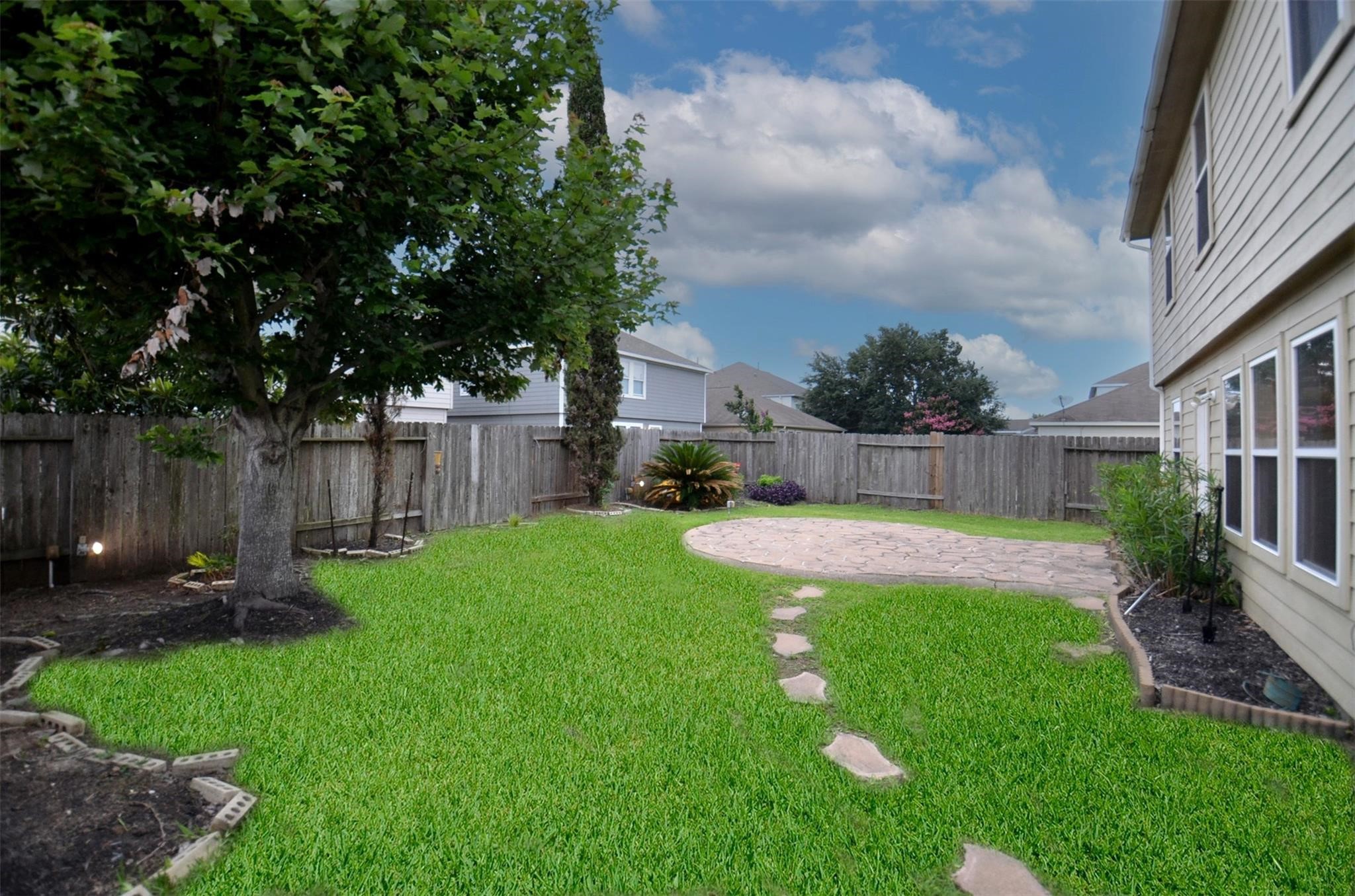 3603 Barkers Crossing Avenue Houston, TX 77084 - Photo 33 of 34 a view of backyard with table and chairs and wooden fence