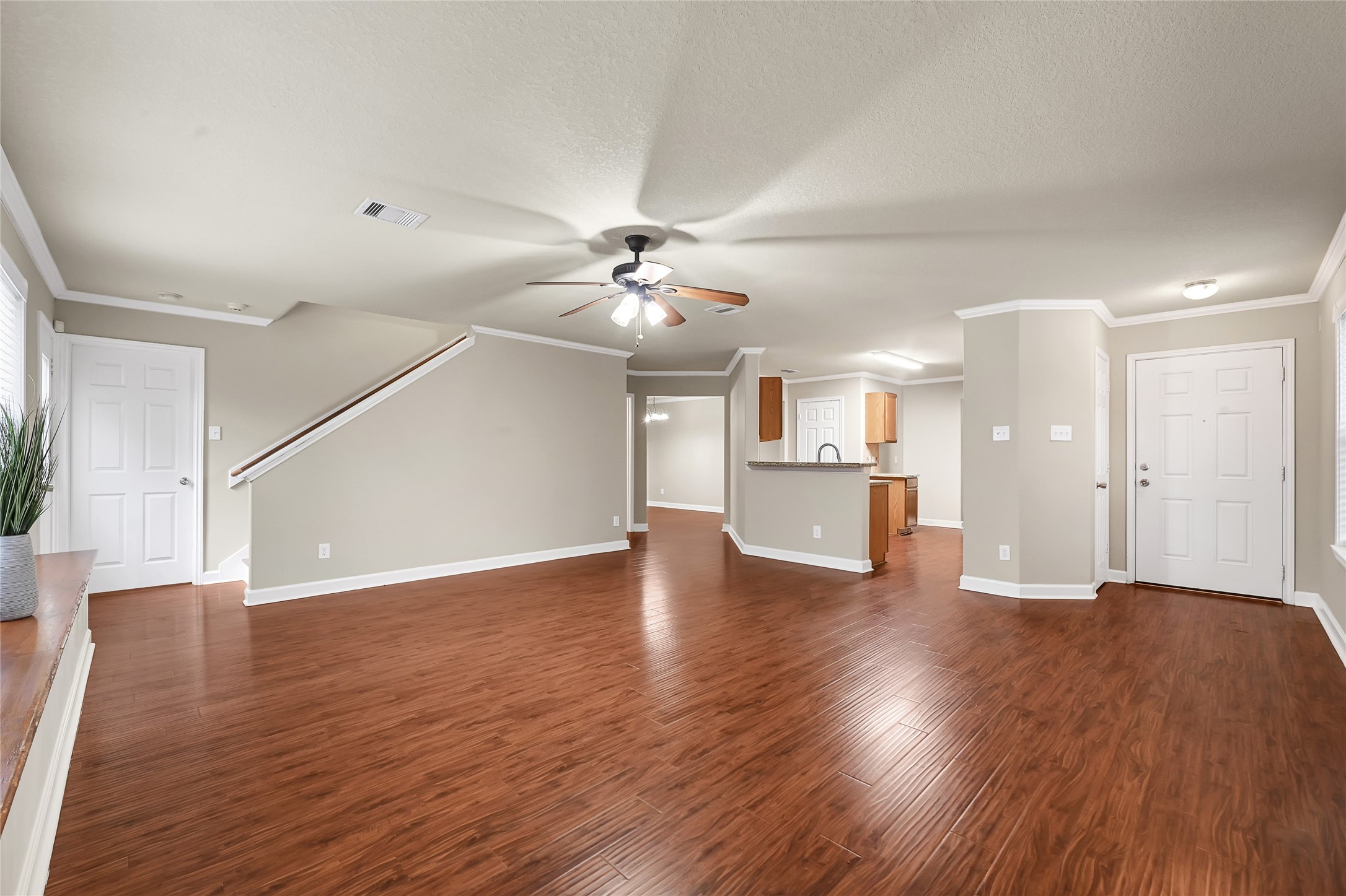 3603 Barkers Crossing Avenue Houston, TX 77084 - Photo 5 of 34 a view of an empty room with wooden floor and a kitchen