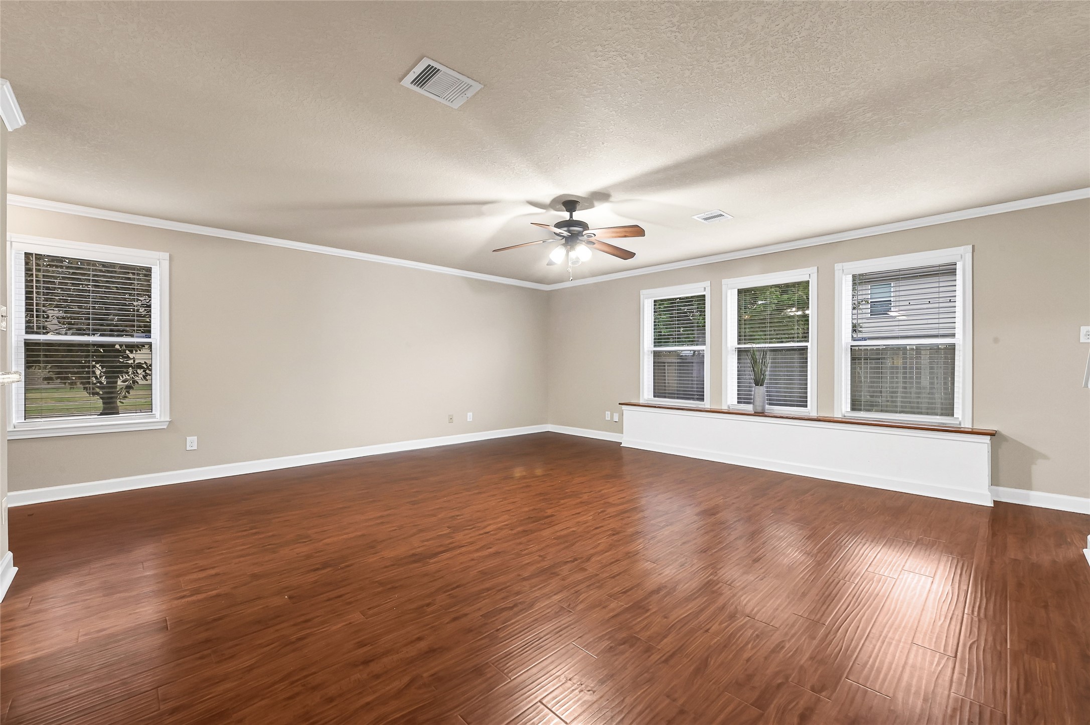 3603 Barkers Crossing Avenue Houston, TX 77084 - Photo 7 of 34 a view of an empty room with wooden floor and a window