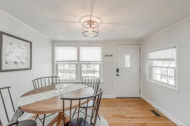 a view of a dining room with furniture window and wooden floor