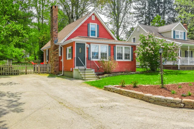a front view of house with yard and green space