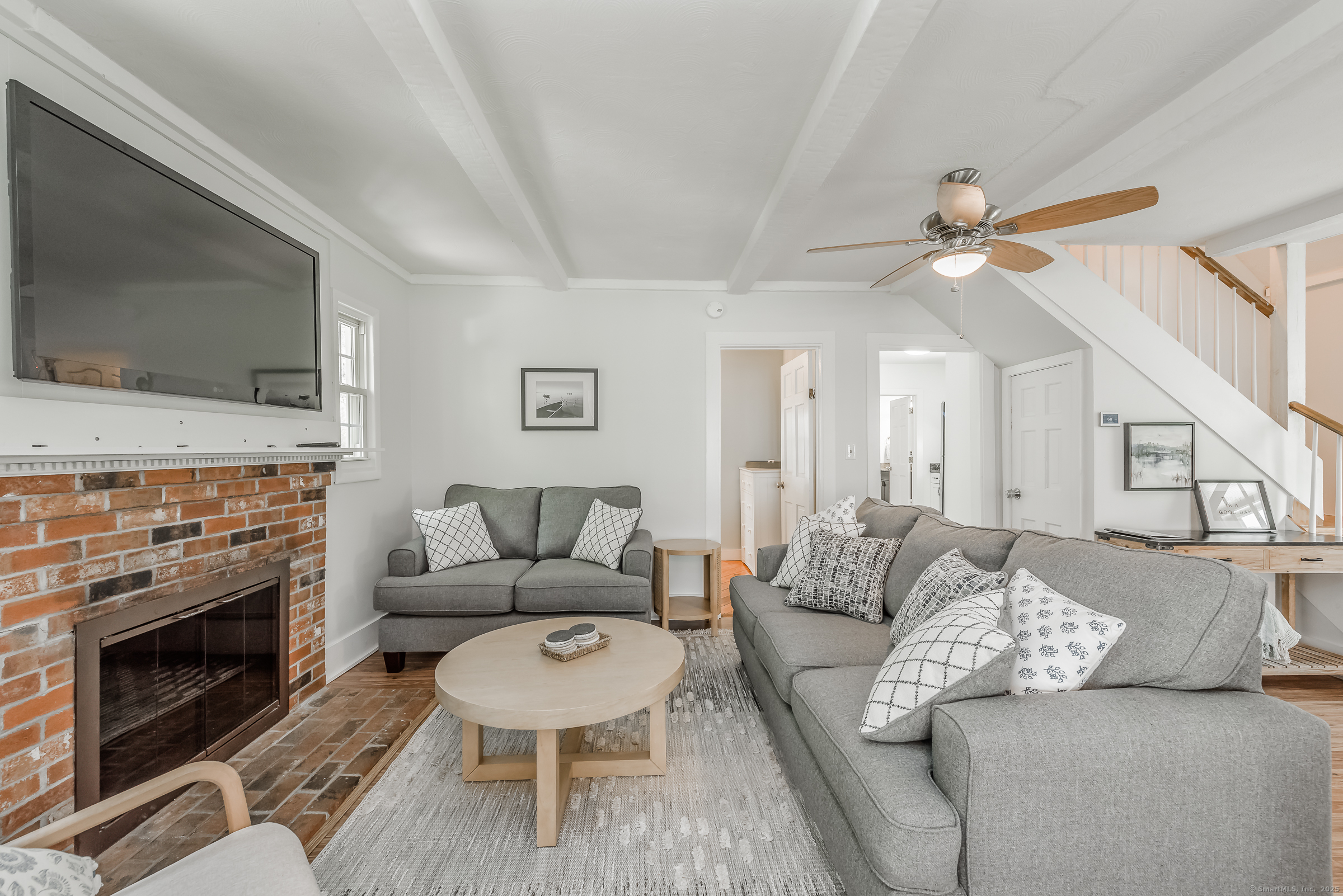 21 Elsmere Road Hebron, CT 06231 - Photo 5 of 31 a living room with furniture a flat screen tv and a fireplace
