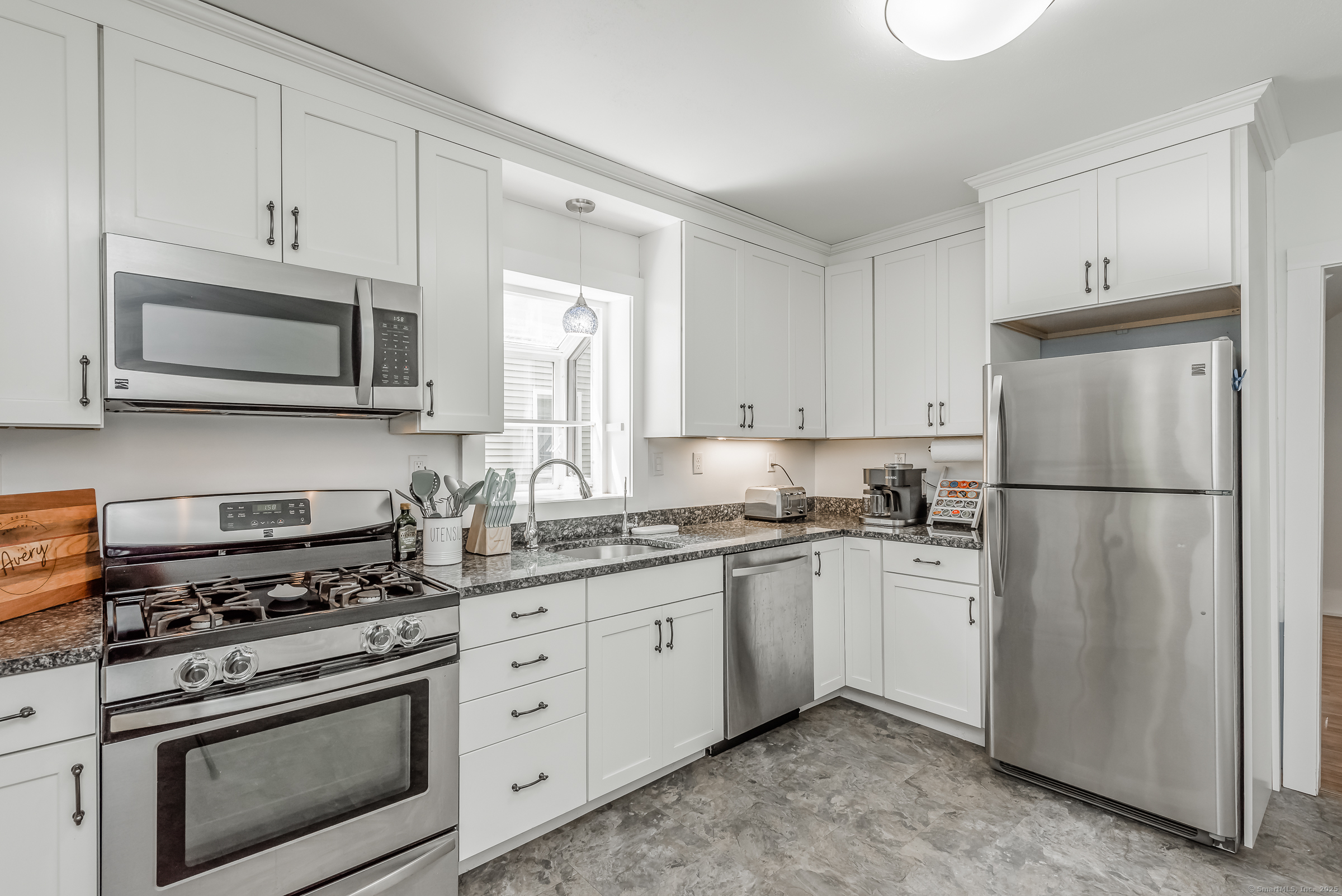 21 Elsmere Road Hebron, CT 06231 - Photo 9 of 31 a kitchen with cabinets stainless steel appliances and wooden cabinets
