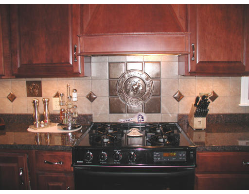 641 Marys Pond Road Rochester, MA 02770 - Photo 9 of 12 a kitchen with a stove and cabinets