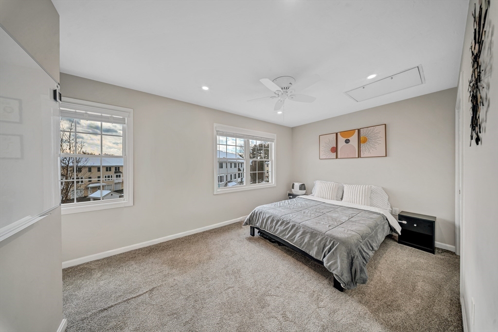41 Boston Road, Unit 121 Billerica, MA 01862 - Photo 11 of 13 a bedroom with a bed and a window