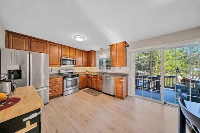 a large kitchen with a large window and stainless steel appliances
